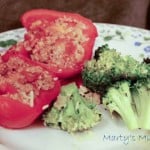 Red pepper stuffed with meat mixture, served with broccoli on flower plate