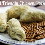 chicken and cream cheese filling wrapped in biscuit, rolled in butter and bread crumbs and served on plate with pretzels
