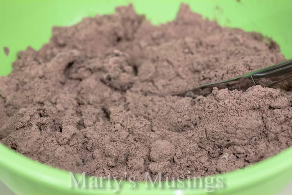 Almost Like Candy Bars chocolate brownie mixture topped with whipped topping on a white plate