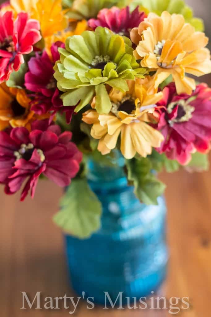 Silke flowers in antique blue bottle