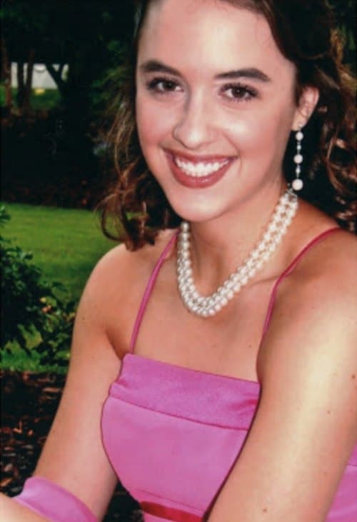High school girl in pink prom dress with pearls