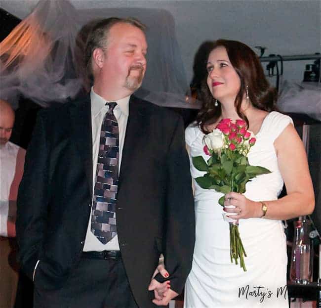 Husband and wife gazing at each other at 25th wedding anniversary vow renewal service