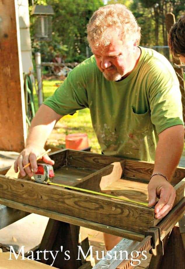 A man standing on top of a wooden table, with Inviting Natural