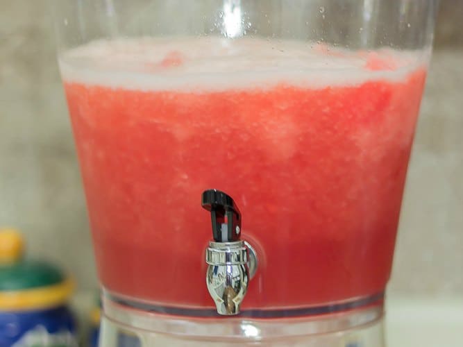 Red frozen punch in tall dispenser