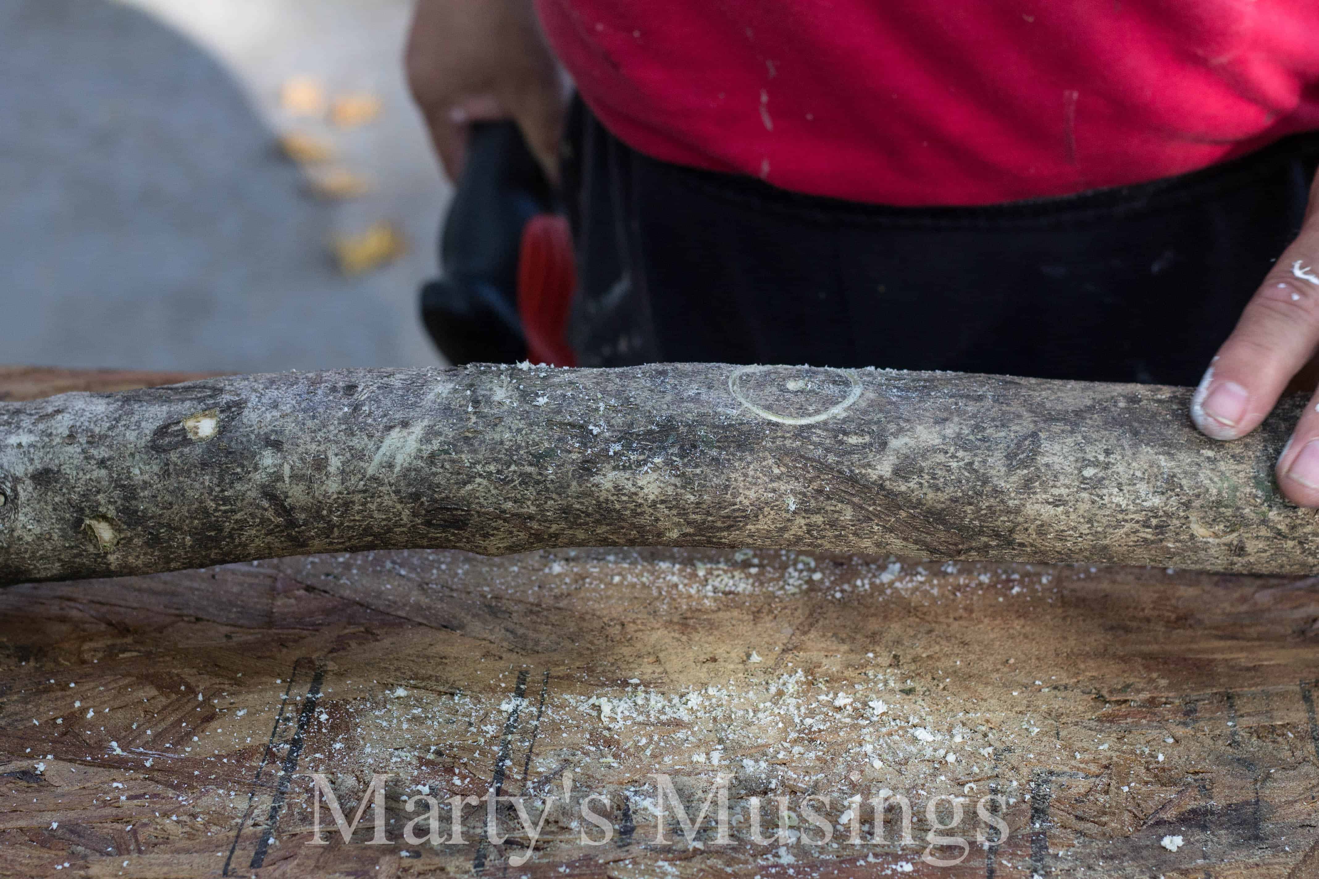 drilling holes in a branch for a centerpiece