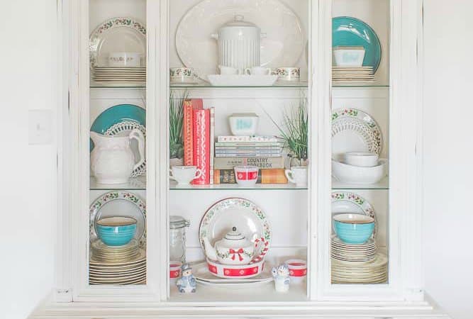 White hutch decorated with blue and red dishes