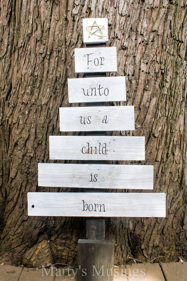 A wooden park bench sitting in front of a sign