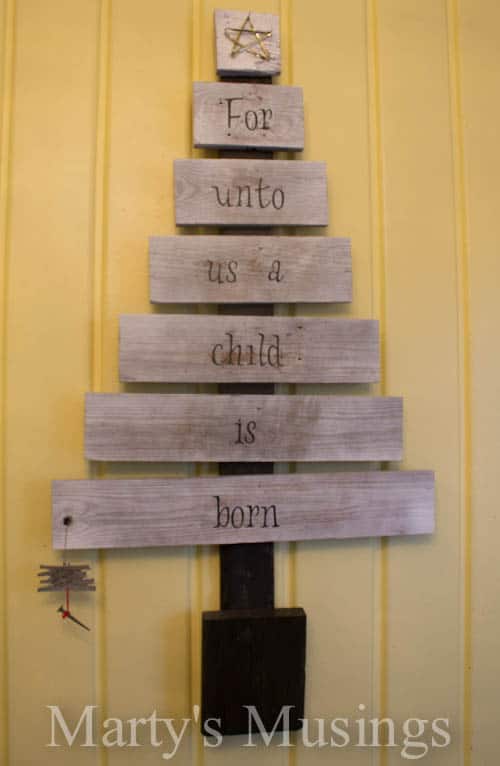 Want unique repurposed holiday decor you can make yourself? This creative scrap wood Christmas tree is made from old fence boards with vinyl letters