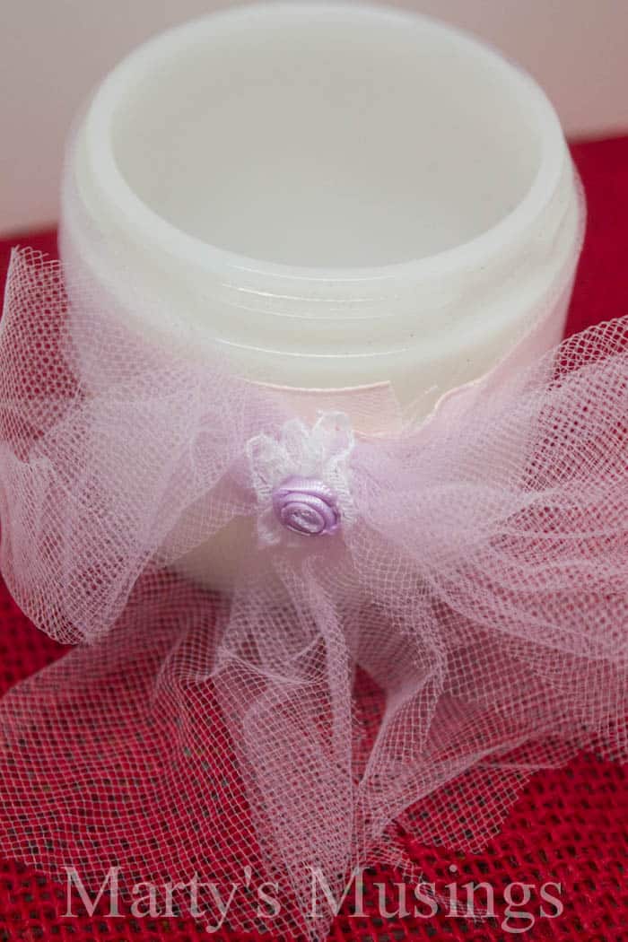 A close up of a coffee cup, with Candle and Jar