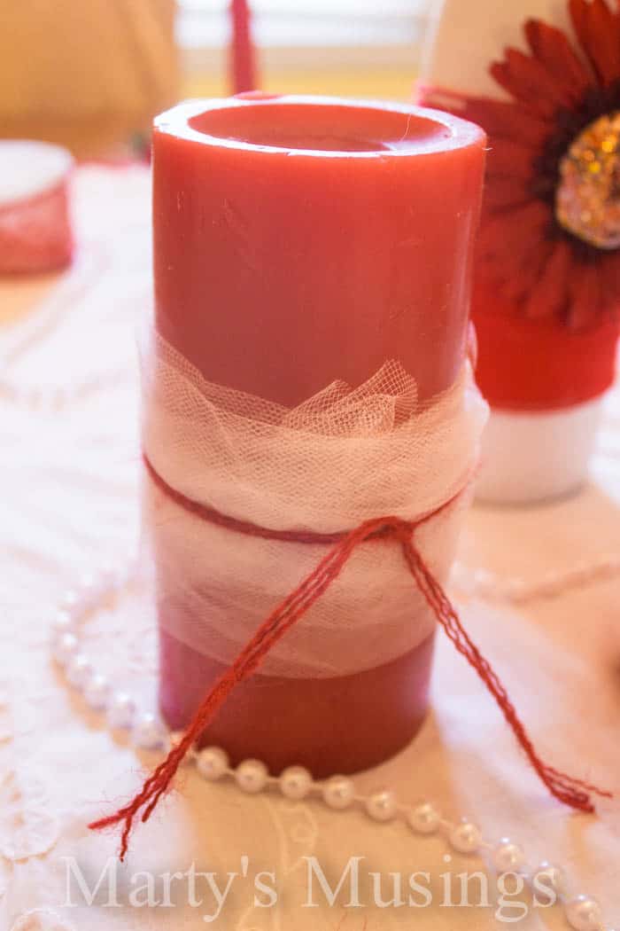 A close up of a coffee cup, with Candle and Jar