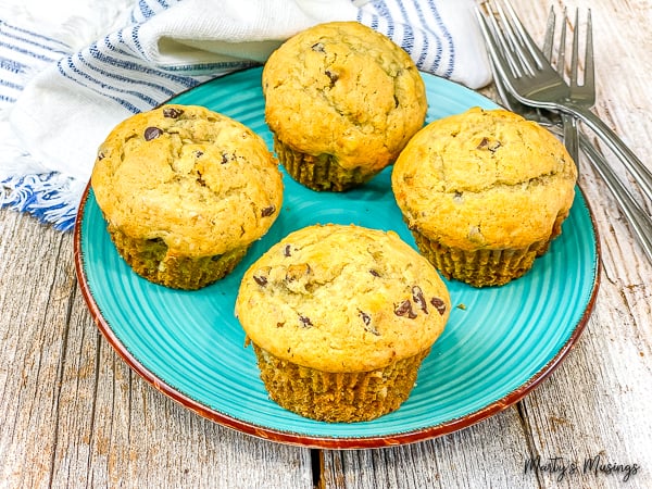 Chocolate Chip Banana muffins on a blue plate on wood table