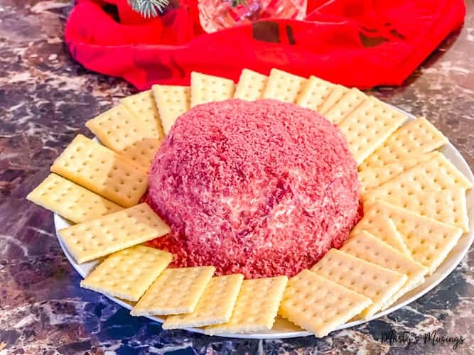 Dried beef cheese ball and crackers on white plate