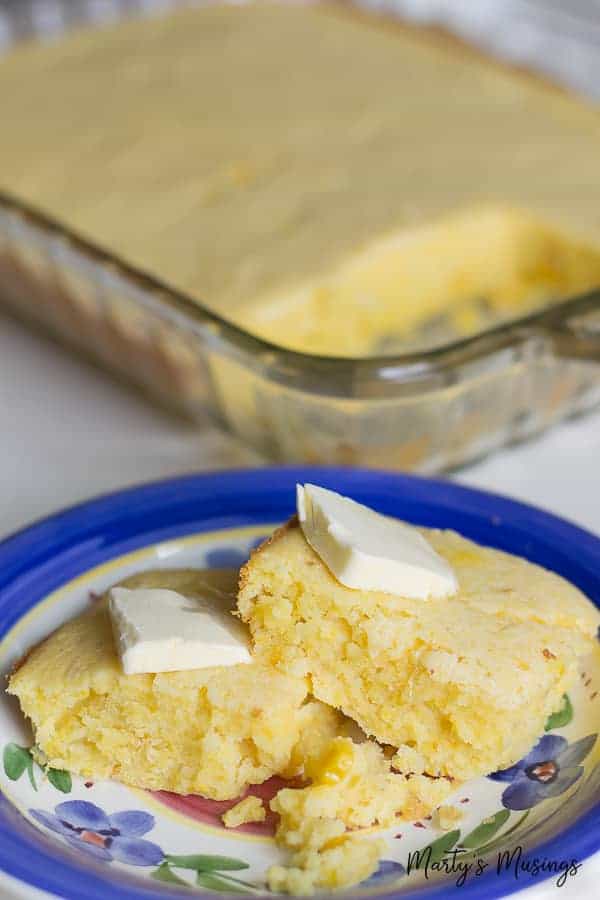 Jiffy corn bread with butter on top on blue flower plate