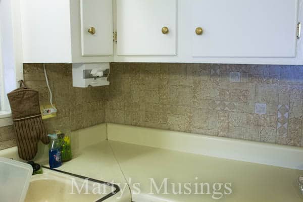 A kitchen with a sink and a mirror