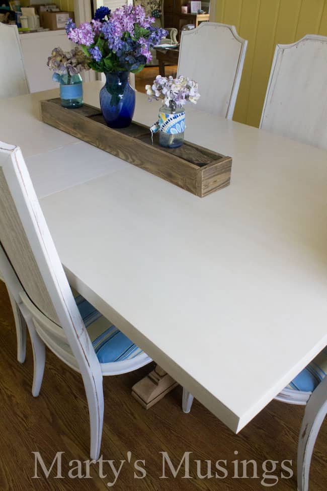 white kitchen table with wooden box centerpiece