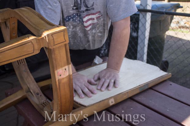 A person sitting on a wooden bench