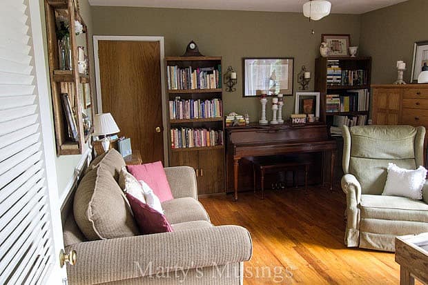 A living room filled with furniture and a book shelf