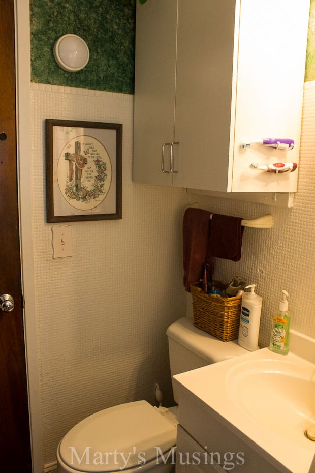 Dated bathroom with white tiled walls