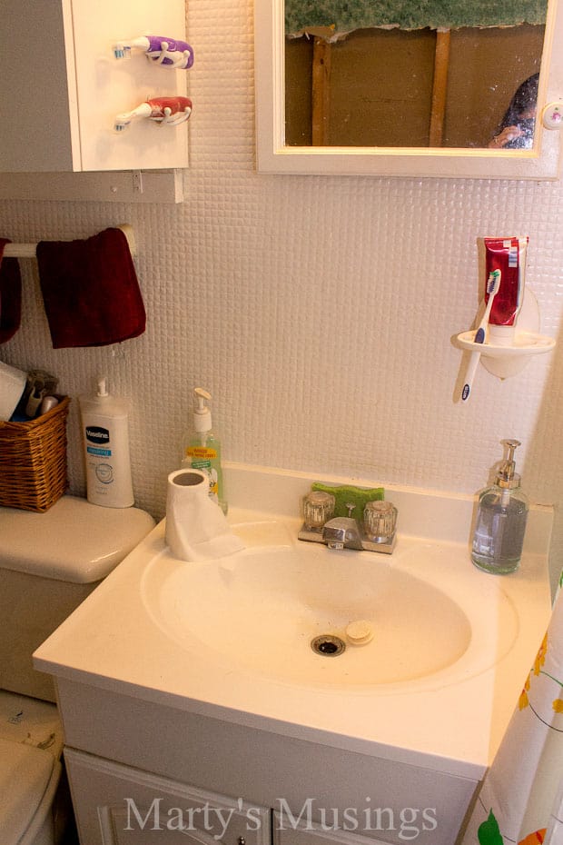 Dated bathroom with white tiled walls