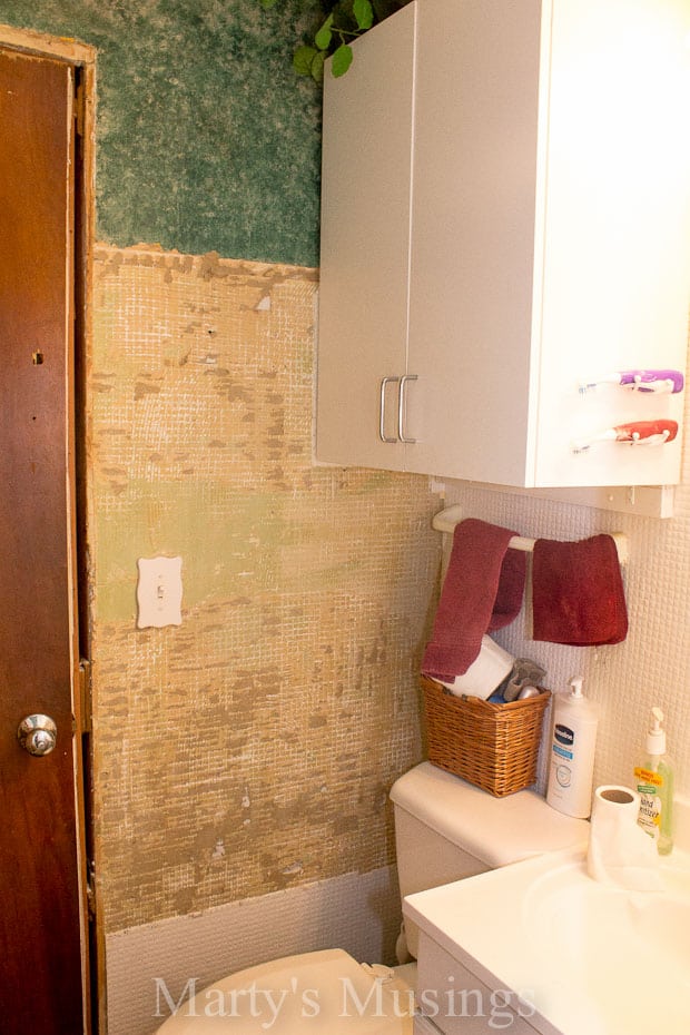 Dated bathroom with sheetrock and tile removed