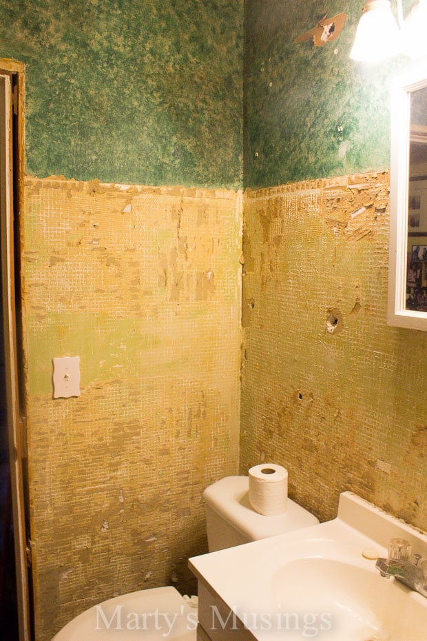 Small bathroom with sheetrock and tile removed