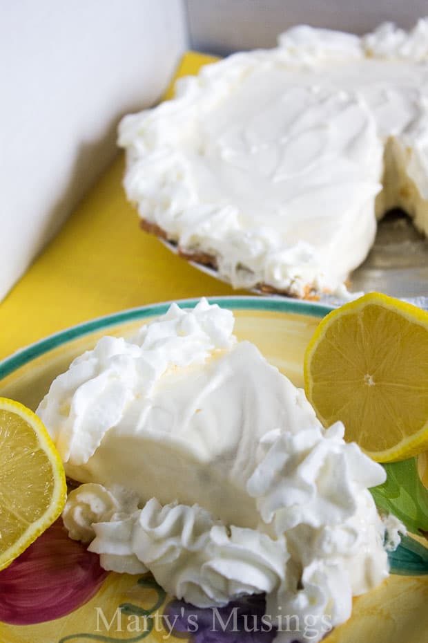 A piece of cake on a plate, with Cream and Lemon