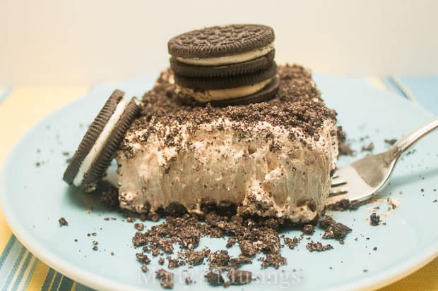 Chocolate Mousse Cheesecake on plate with oreos and cream cheese.