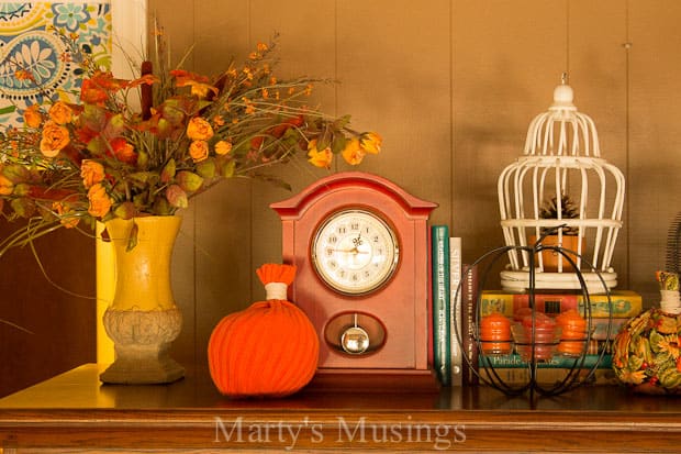 A clock sits at the top of a wooden table