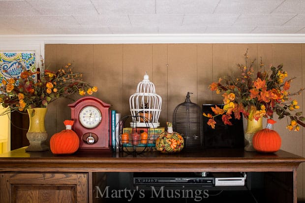 A room filled with furniture and vase of flowers on a table