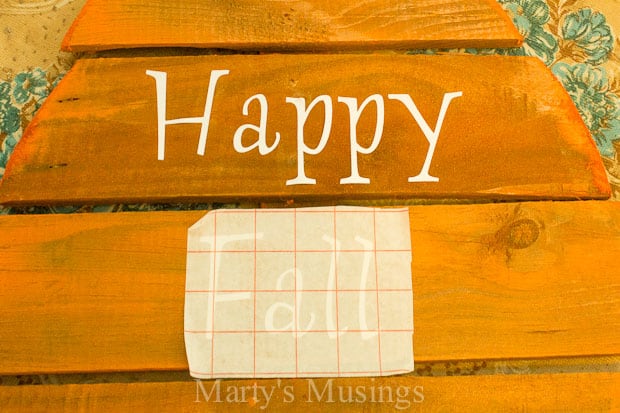 Happy fall stenciled letters on wood pumpkin