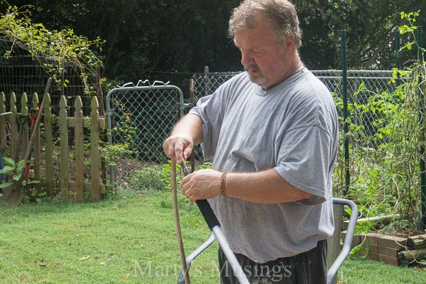 A man standing next to a fence