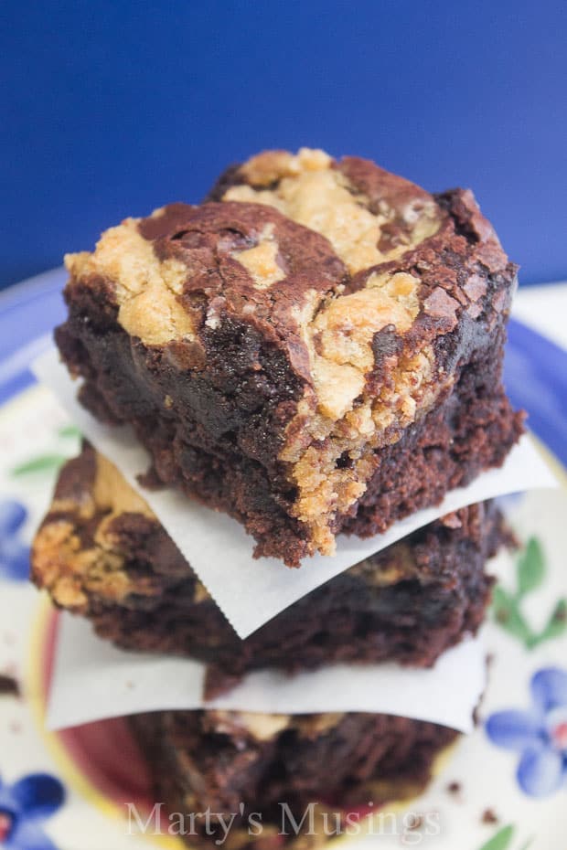 A piece of chocolate cake on a plate, with Cookie and dough