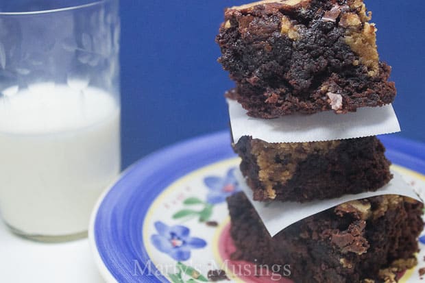 A piece of chocolate cake on a plate, with Cookie and Dough