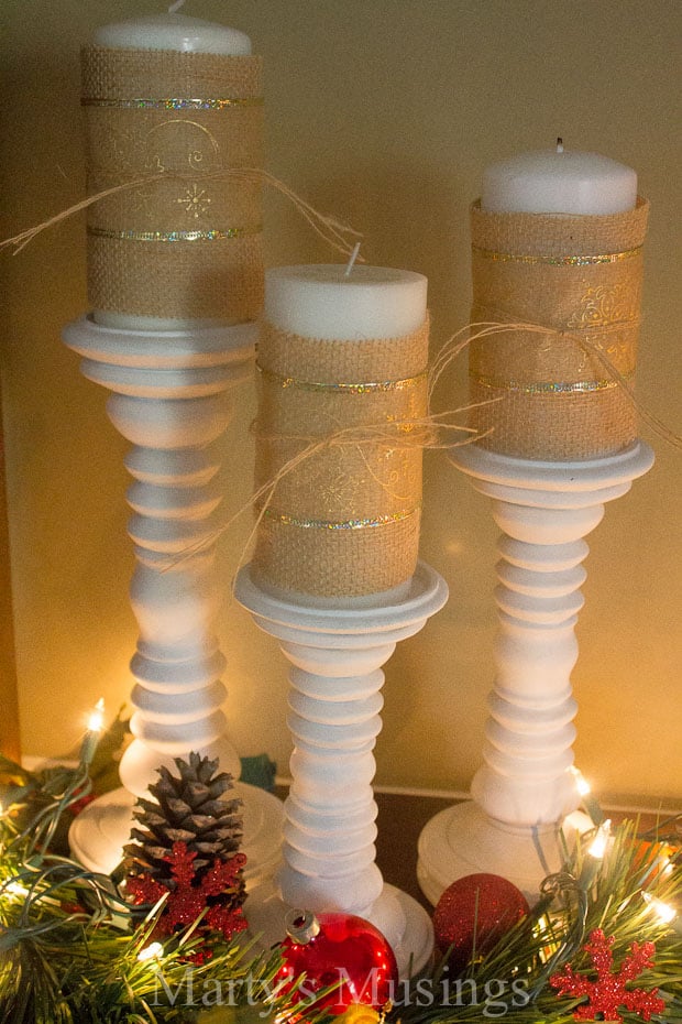 A group of glass bottles on a table, with Ornament and Christmas tree