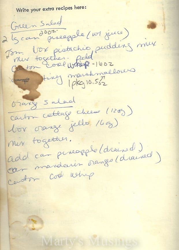 Old cookbook page with green and orange salad recipes