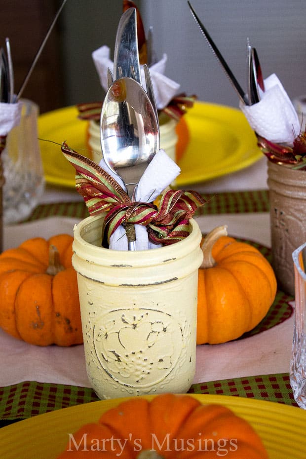 A glass of orange juice next to a cup of coffee on a table, with Thanksgiving and Jar