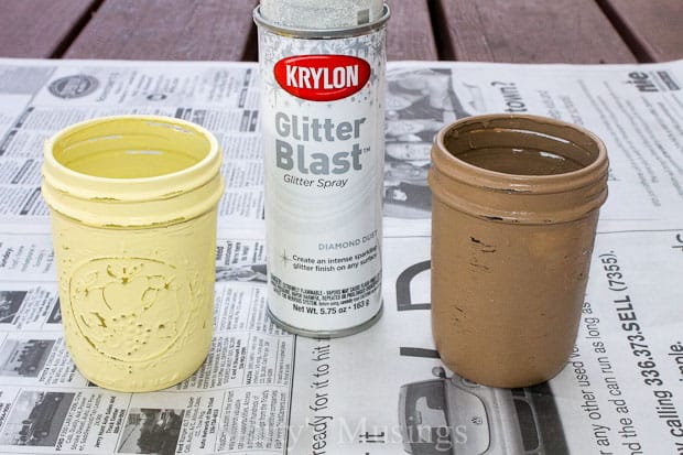 A cup of coffee and a glass of beer on a table, with Tin and Jar