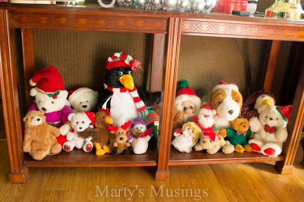 A group of stuffed animals sitting on top of a wooden shelf
