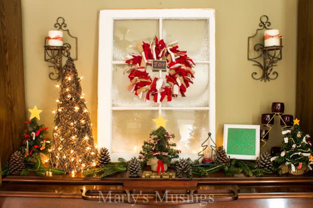 A vase of flowers on a table next to a christmas tree