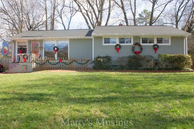 A group of people standing in front of a house