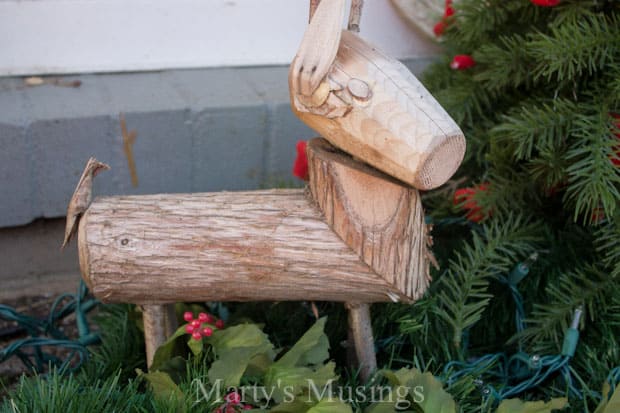 A bird sitting on top of a wooden bench