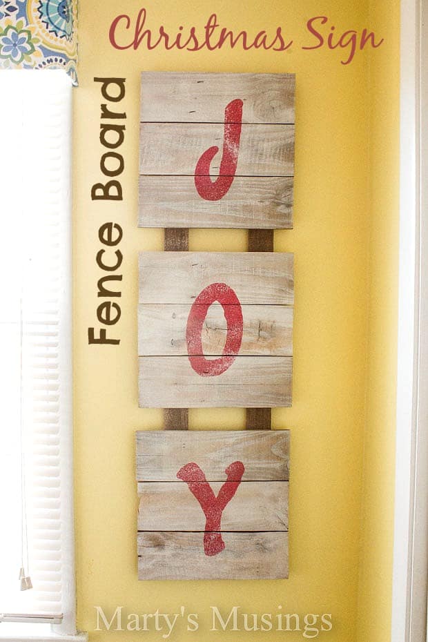 Easy step by step tutorial for a fence board Christmas sign using repurposed wood, spray paint and a stencil. Perfect for the holidays!