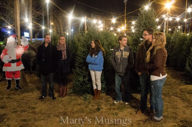 A group of people standing in front of a crowd posing for the camera