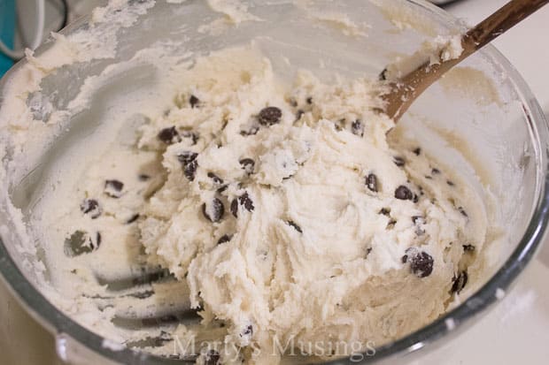 A bowl of food on a plate, with dough