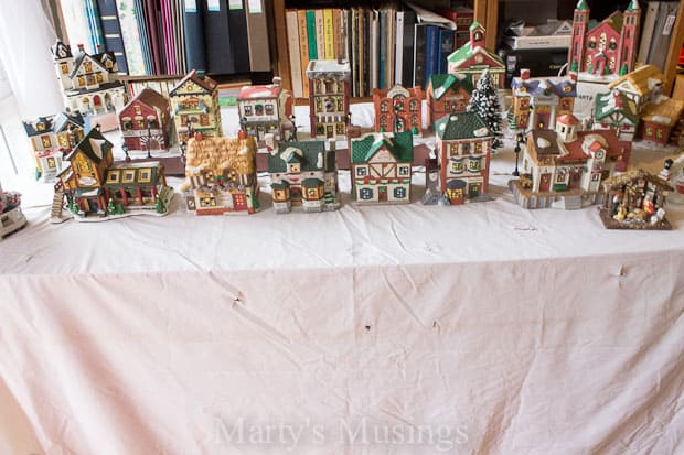 Christmas village setup in front of bookcase