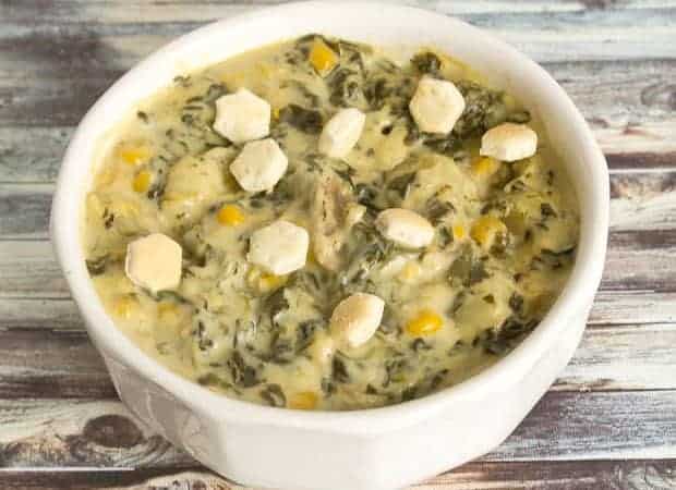 White bowl of spinach and pasta soup