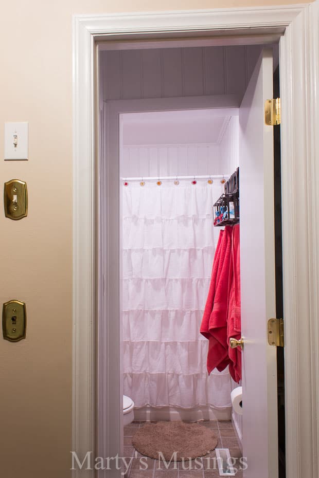 A shower with a towel hanging on the wall