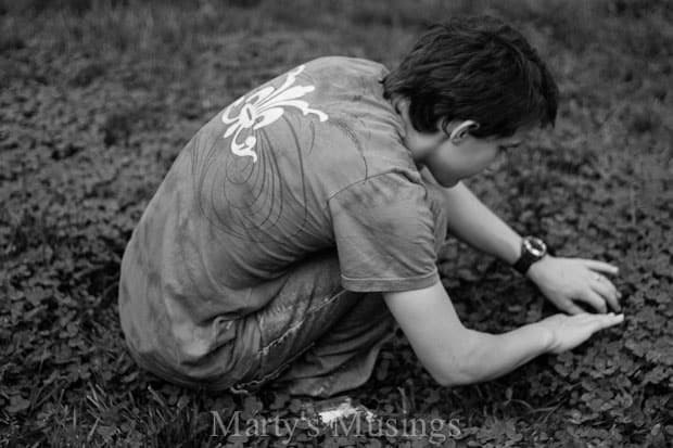 A little boy that is standing in the grass