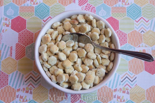 A bowl of food on a plate, with Cracker and Oyster