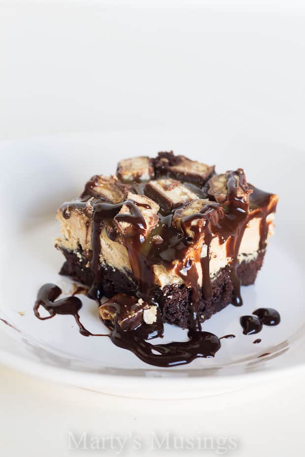 Snickers Brownie Ice Cream Cake with syrup on white plate - Marty's Musings